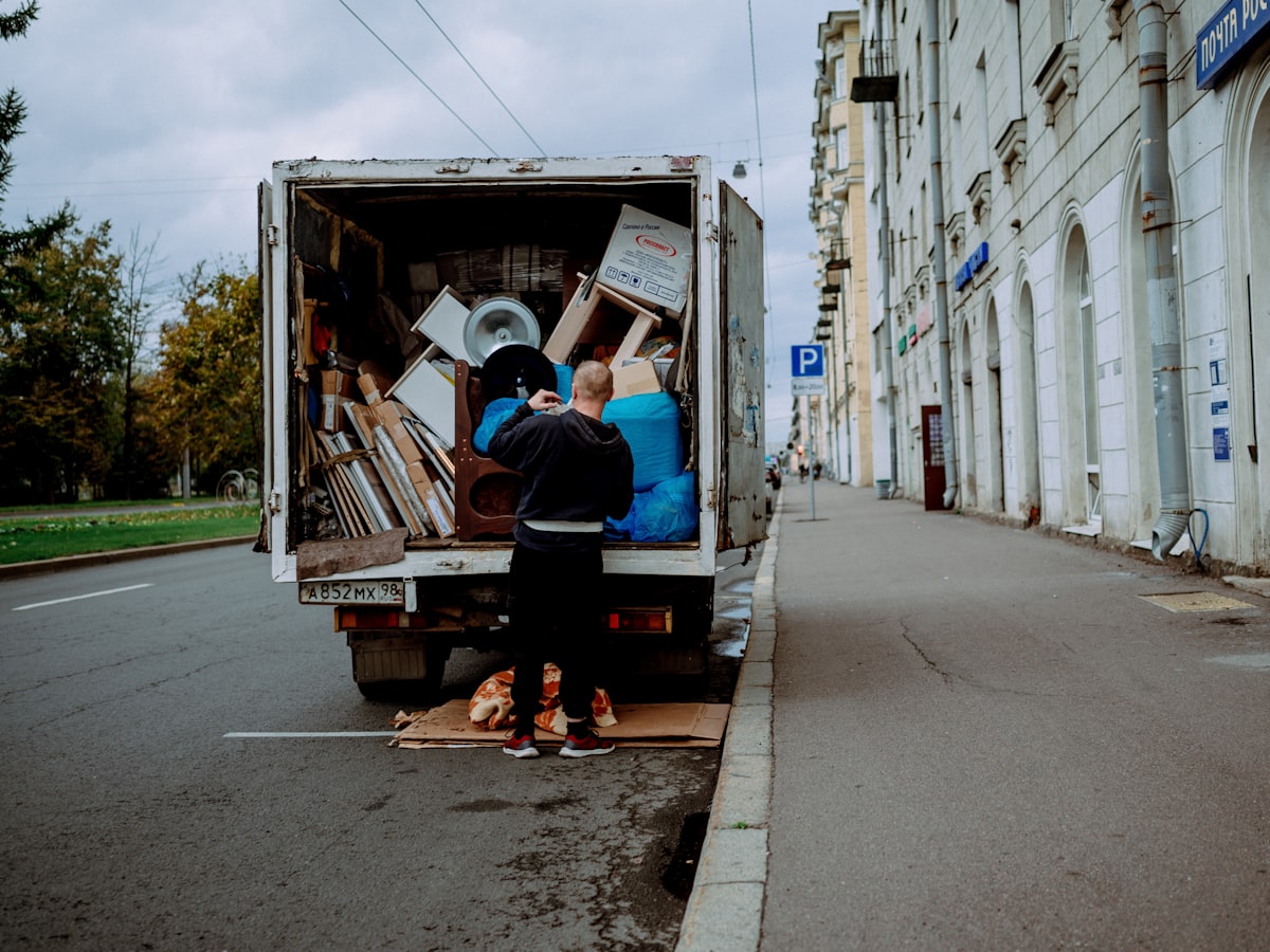 A mover unloading furniture from a truck