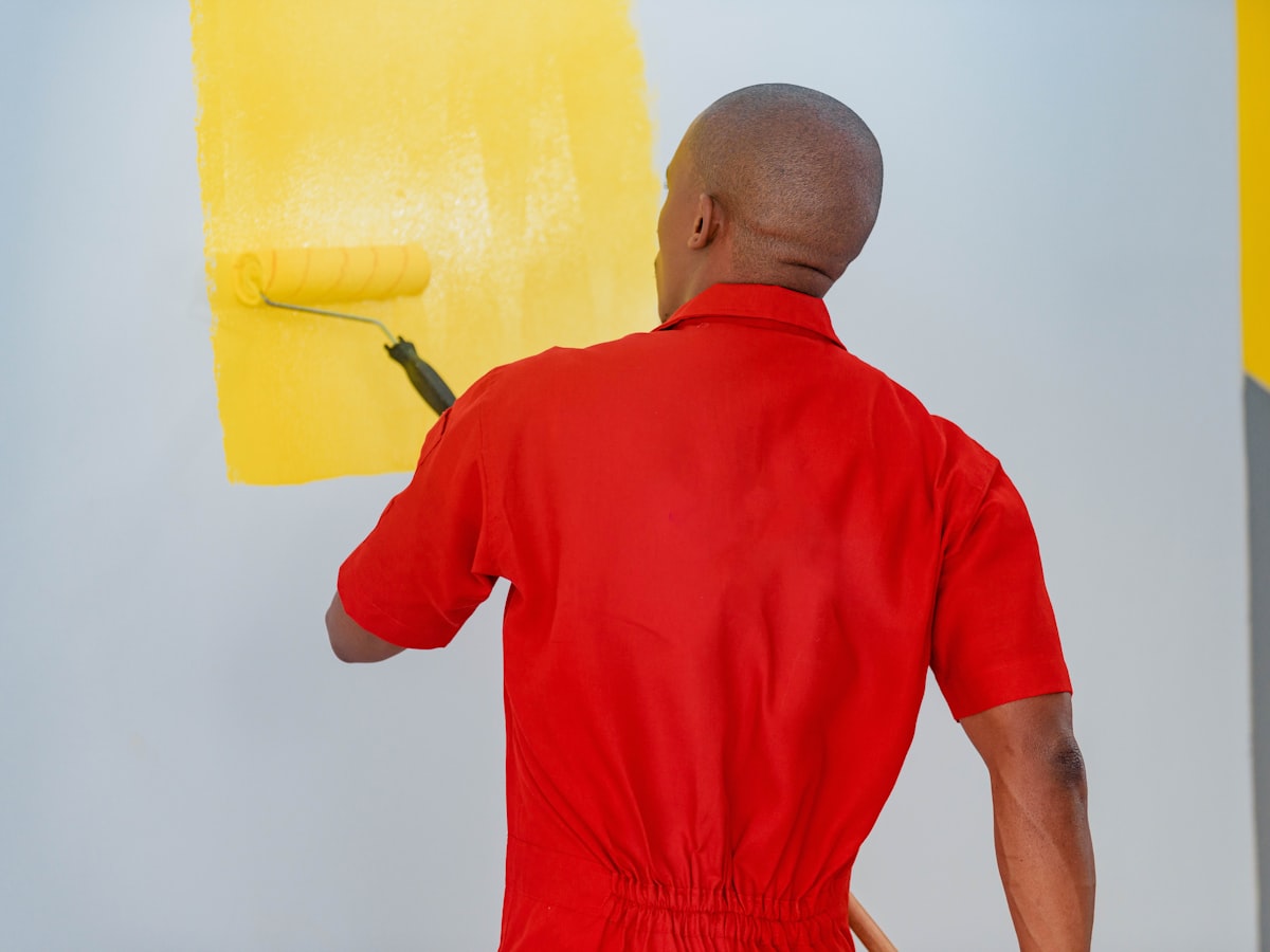 A painter rolling colour onto an interior wall