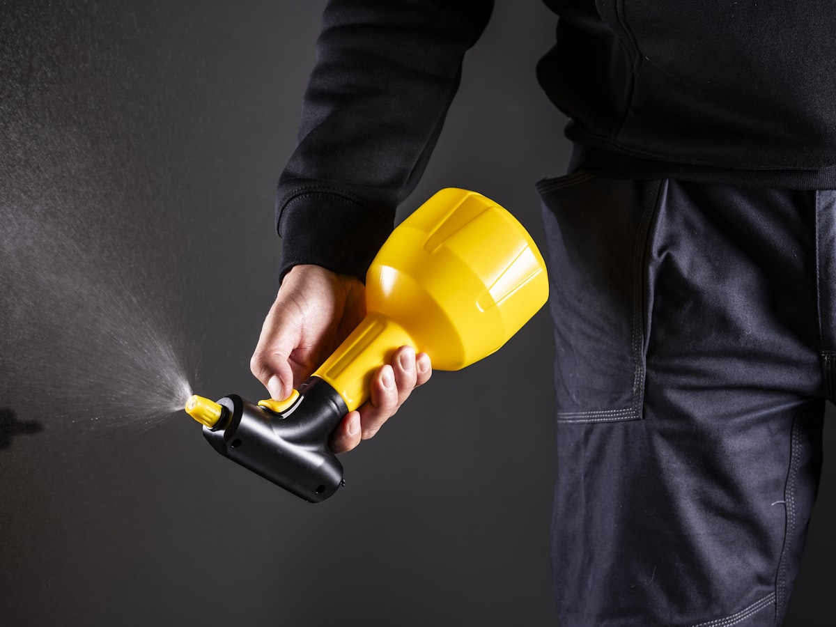 A technician applying a treatment with a sprayer