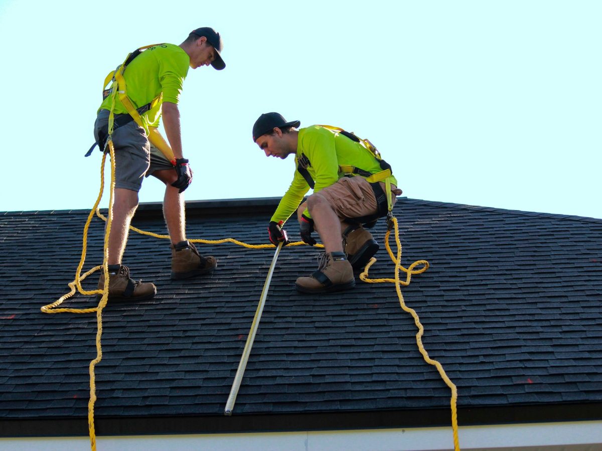 A roofer fitting slate on a pitched roof