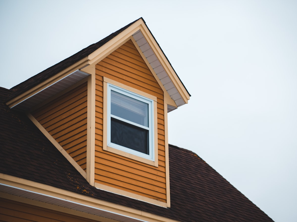 Timber siding and a dormer window on a house
